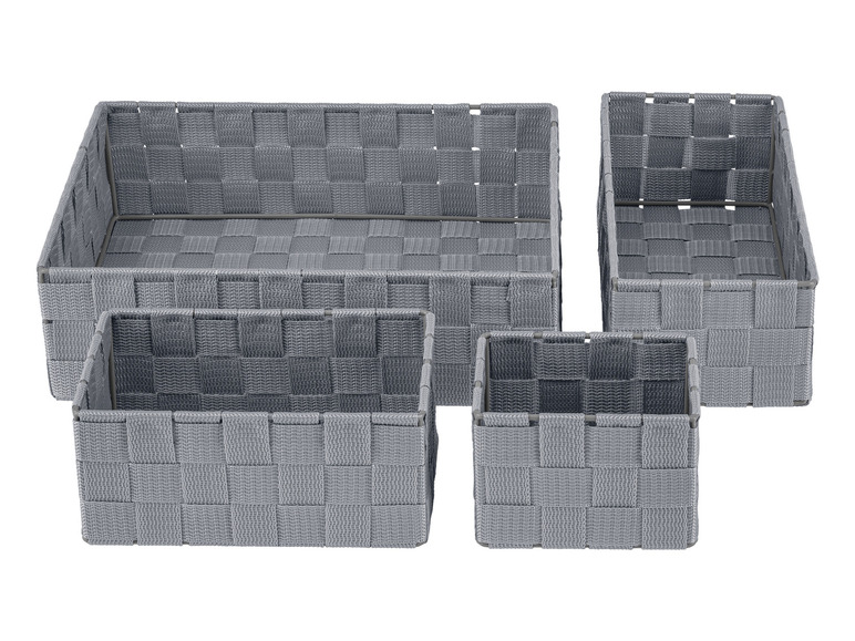 Vier grijze opbergmanden van geweven materiaal.