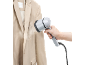 Handstomer strijkt een beige jas glad