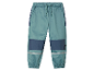 Kinder joggingbroek, blauwgroen met donkerblauwe en reflecterende details.