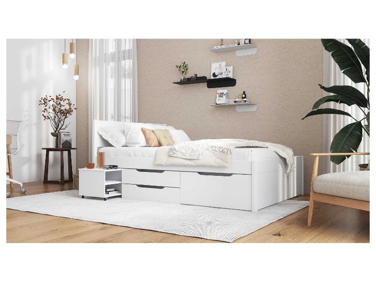 Modern wit bed met laden en nachtkastje.