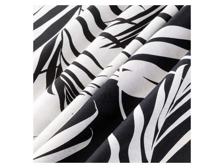 Zwart-wit gestreepte stof met een tropisch bladmotief.