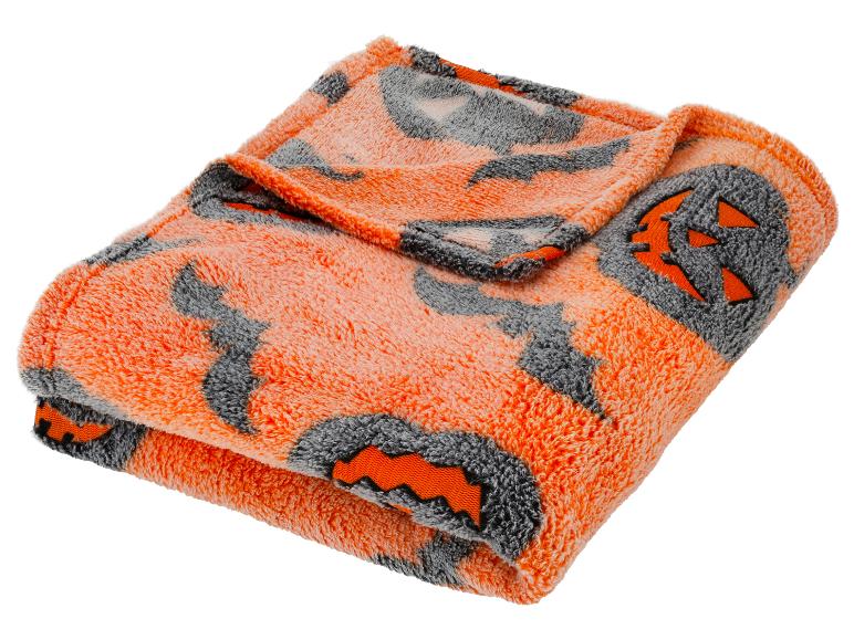 Oranje-grijze deken met Halloween pompoenmotieven.