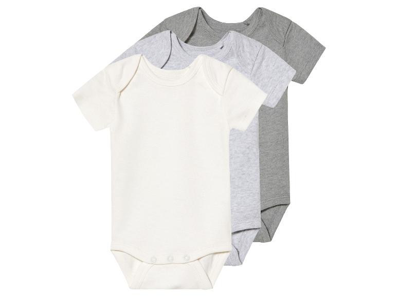 Drie baby rompers, wit en grijs.