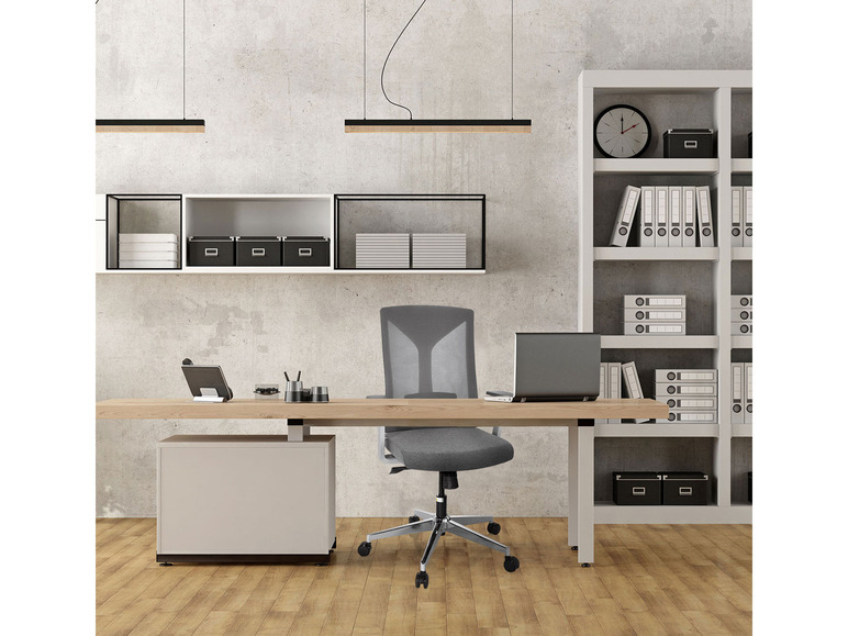 Een modern kantoor met een bureaustoel, een bureau en een boekenkast.