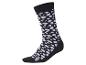 Zwarte sok met witte, onregelmatige vlekken