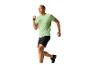 Man in groene T-shirt en zwarte shorts aan het rennen.