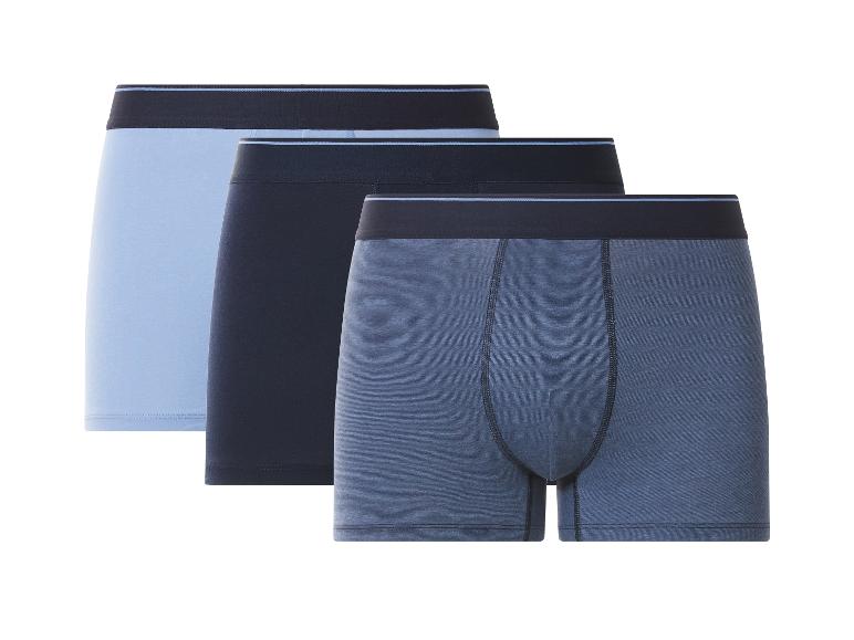 Drie herenboxershorts in blauwtinten: lichtblauw, donkerblauw en gemêleerd blauw.