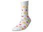 Witte sok met een patroon van gele en roze eendjes.