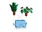 Twee verwisselbare LEGO-planten en een blauwe plantenbak met een lachend gezicht.