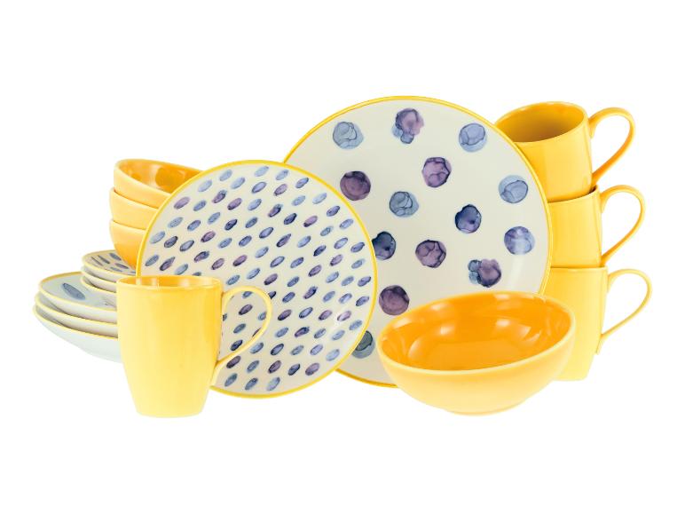 Geel en wit gestippeld servies met borden, kommen en mokken