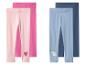 Twee sets kinderleggings: roze met uitgesneden hart en blauw met eenhoorn.
