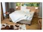 Moderne slaapkamer met bed, wit beddengoed, nachtkastjes en een koeienhuid vloerkleed.