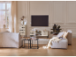 Moderne woonkamer met elegante meubels, comfortabele banken en een tv aan de muur.