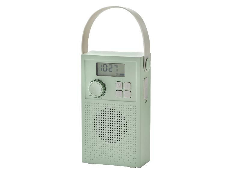 Mintgroene draagbare radio met digitaal display en draagbeugel.