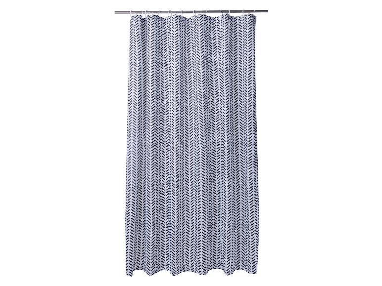Wit douchegordijn met zwart visgraatpatroon, hangend aan een stang