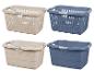 Vier wasmanden in beige en blauw met handvatten.
