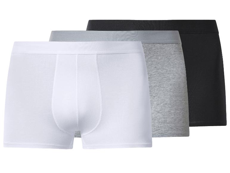 Drie herenboxershorts in wit, grijs en zwart.
