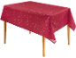 Rood tafelkleed met wit sterrenpatroon op een houten tafel.