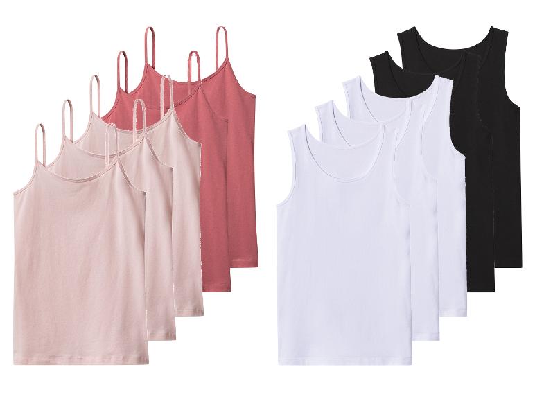 Zes damestops: drie roze spaghettibandjes en drie witte/zwarte mouwloze tops