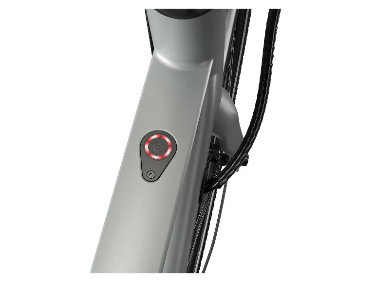 Een grijs frame van een elektrische fiets met een rode aan/uit knop.