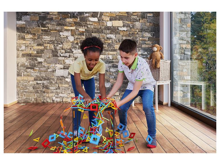Twee kinderen spelen met kleurrijke bouwblokken op een houten vloer.