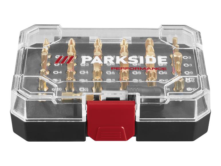 Set gouden schroevendraaierbits in een transparante doos met rode sluiting.