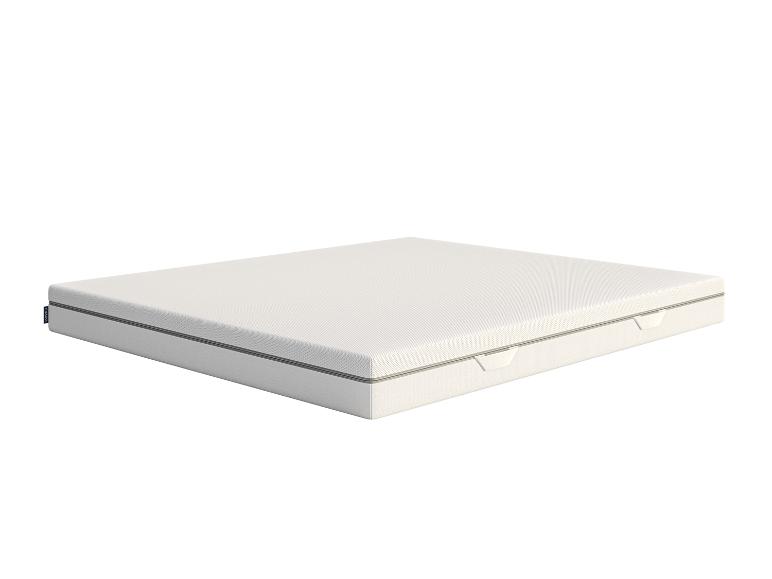 Wit matras met een donkergrijze rits en een blauw label op een witte achtergrond