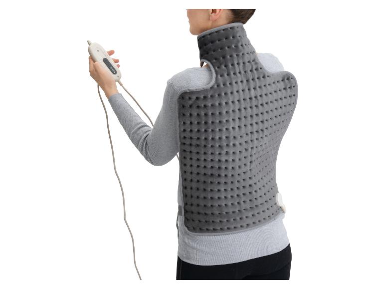 Vrouw draagt een grijs rug- en nekverwarmingskussen, met afstandsbediening.