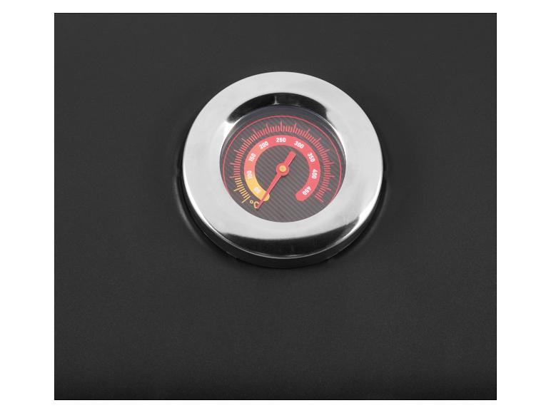 Close-up van een thermometer ingebouwd in een zwart oppervlak, die een temperatuur van ongeveer 270°C aangeeft.