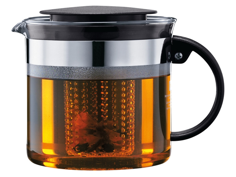 Glazen thee-pot met zwarte handgreep en losse thee in een filter