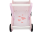 Roze houten babywalker met witte handgreep en stoffen basis met hartjespatroon.