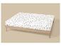 Wit hoeslaken met bruin paddenstoelenpatroon op een licht houten bedframe.