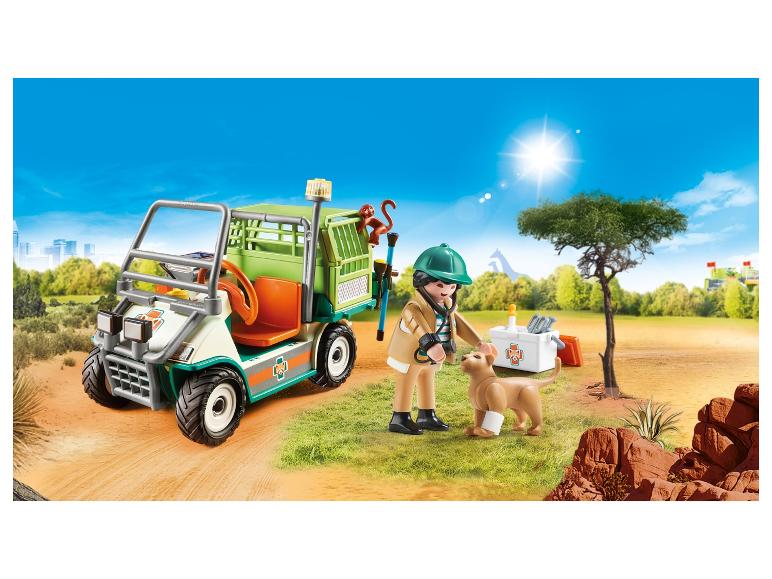 Playmobil dierenarts voertuig met figuur, hond en aap in een safari-achtige omgeving.