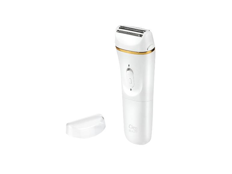 Witte oplaadbare scheerapparaat voor dames met gouden accenten en een transparante dop.