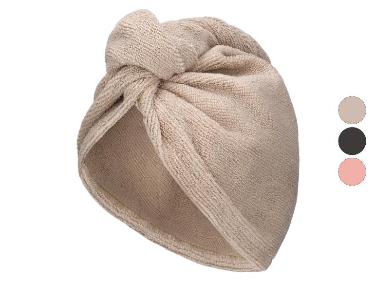 Beige tulbandhanddoek voor haar met een decoratieve knoop aan de voorkant