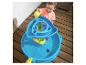Jongen giet water in blauwe watertafel met speelgoed.