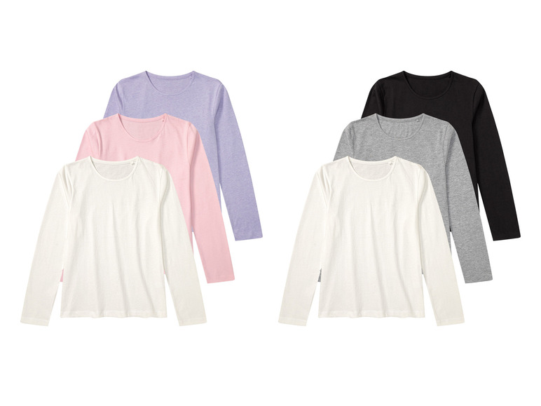 Witte, roze, lichtpaarse en grijze longsleeve shirts met zwarte longsleeve shirt erboven.