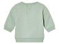 Een lichtgroen longsleeve shirt voor baby's