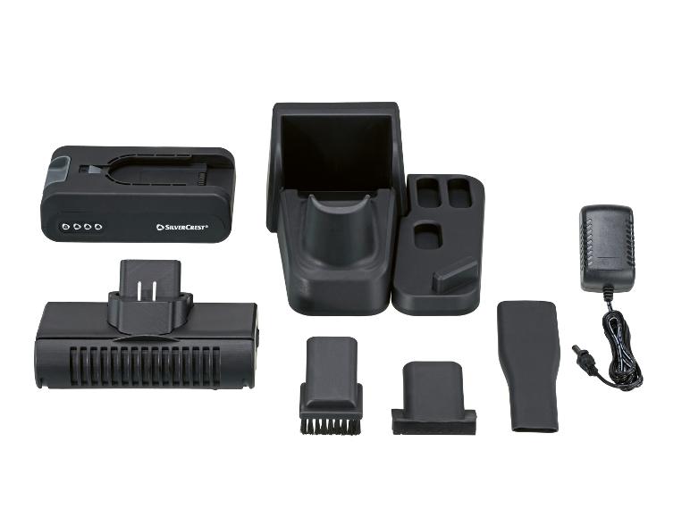 Oplaadstation voor handstofzuiger met accessoires en stroomadapter.