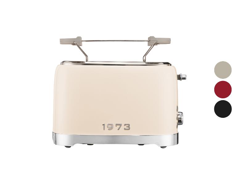 Crèmekleurige broodrooster met metalen accenten en de tekst '1973'.