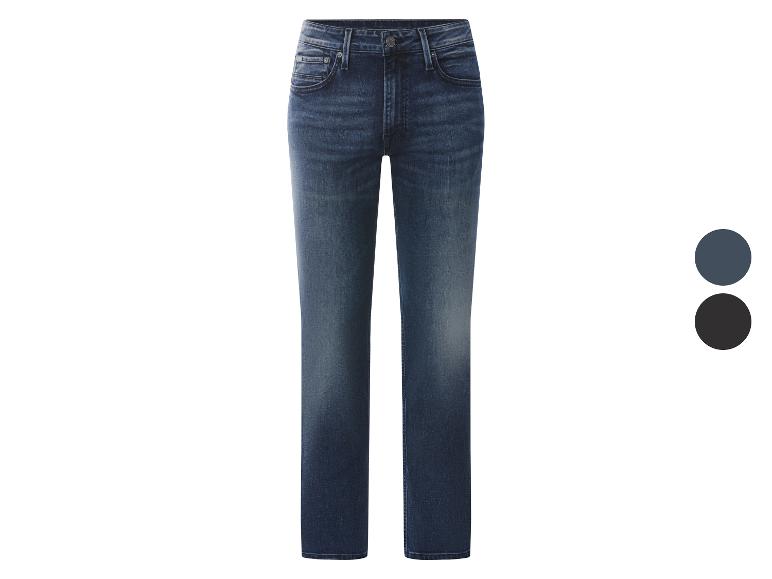 Donkerblauwe herenjeans met vervaagde plekken, met twee kleurstalen ernaast.
