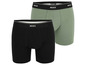Twee paar boxershorts van het merk Mcxx, een zwarte en een groene.