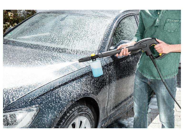 Man wast auto met hogedrukreiniger en schuimsproeier.