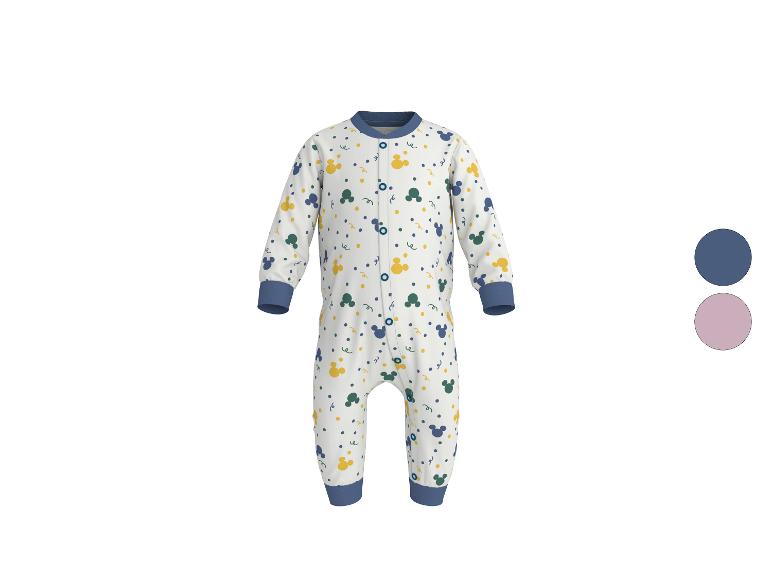 Witte baby romper met blauwe, gele en groene patronen.