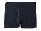 Twee paar donkerblauwe herenboxershorts gevouwen en gestapeld.