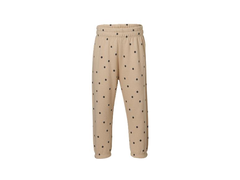 Beige joggingbroek met zwarte stippen, elastische tailleband en boorden.