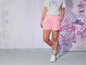 Een model draagt roze shorts en een T-shirt met de tekst 'Stay Cool'.
