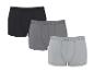 Verpakking van drie katoenen boxershorts in zwart, donkergrijs en lichtgrijs.