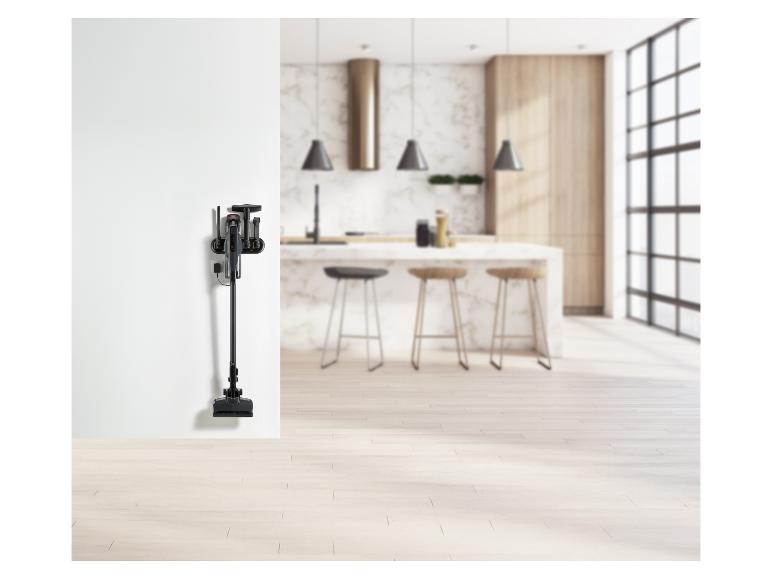 Stofzuiger en accessoires aan de muur in een moderne keuken.