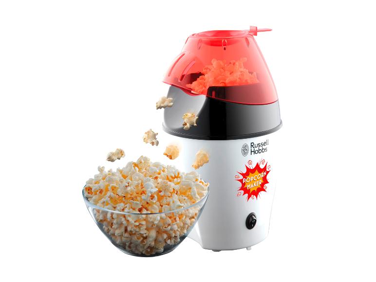 Popcorn in een kom, naast een witte Russell Hobbs popcornmachine.